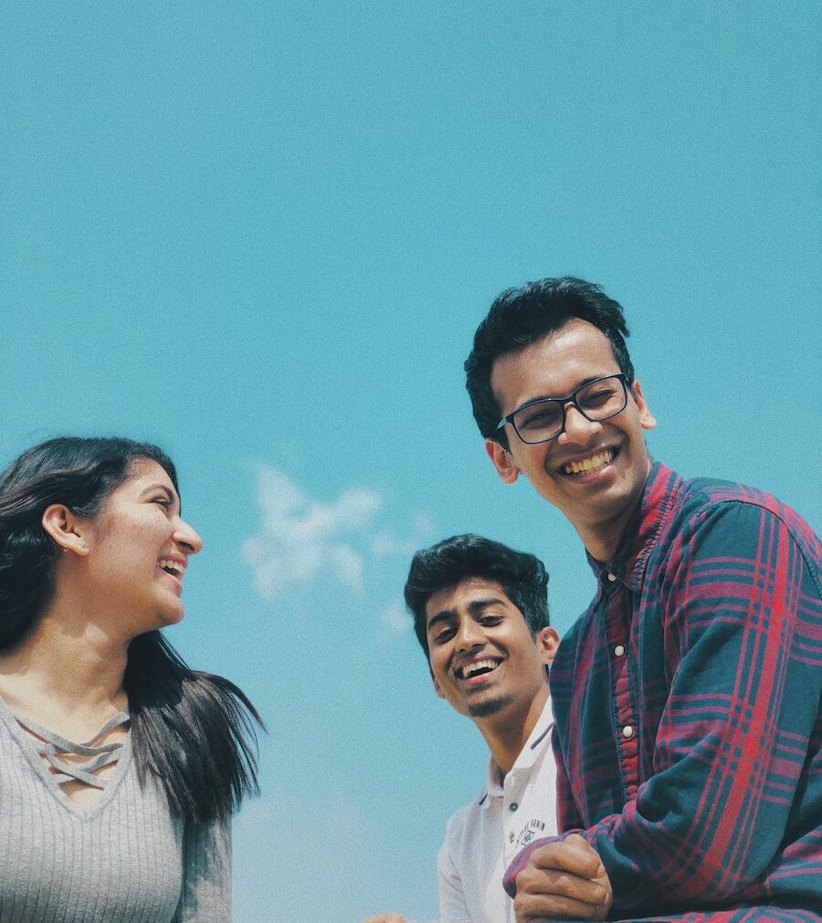 two man facing one woman under white and blue sky at daytime